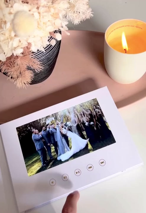 Elegant linen-bound Motion Book displaying a wedding video with premium audio and immersive visuals