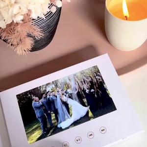 Elegant linen-bound Motion Book displaying a wedding video with premium audio and immersive visuals